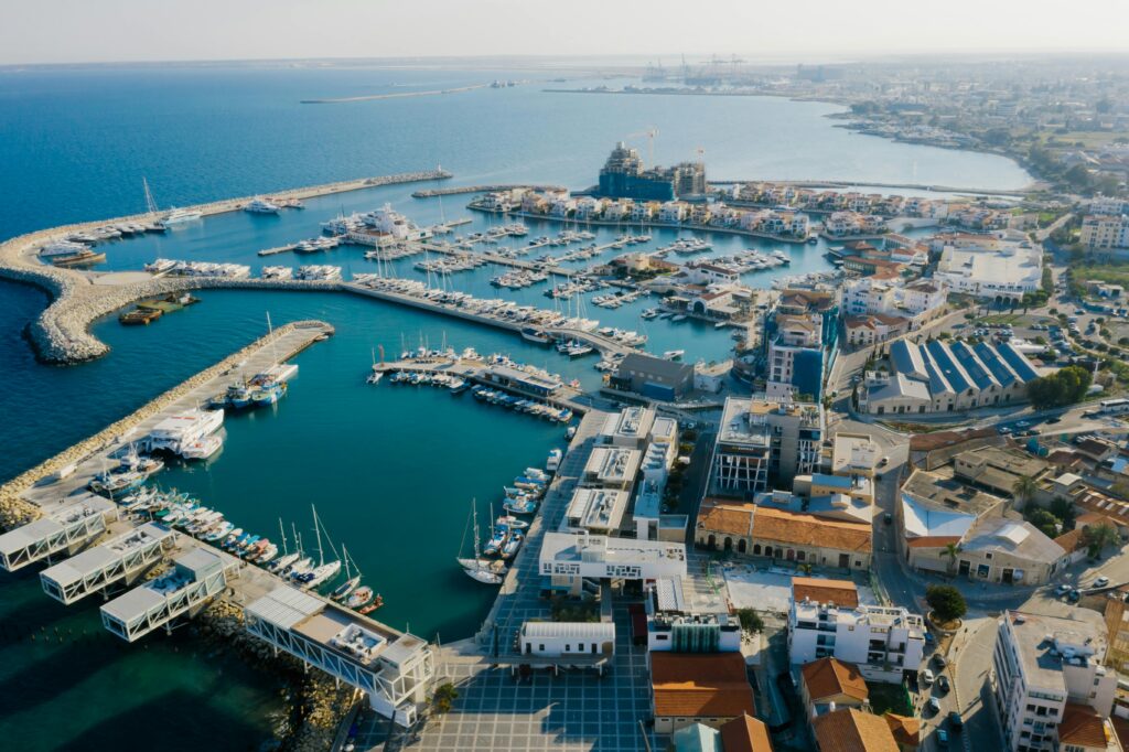 Stunning aerial view of Limassol Marina, Cyprus featuring yachts and urban landscape.
